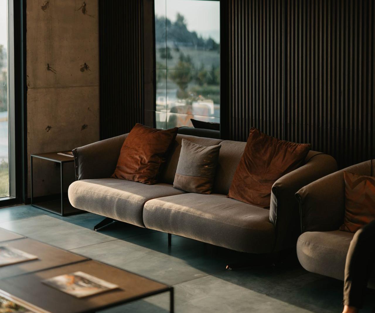 brown and white couch beside window
