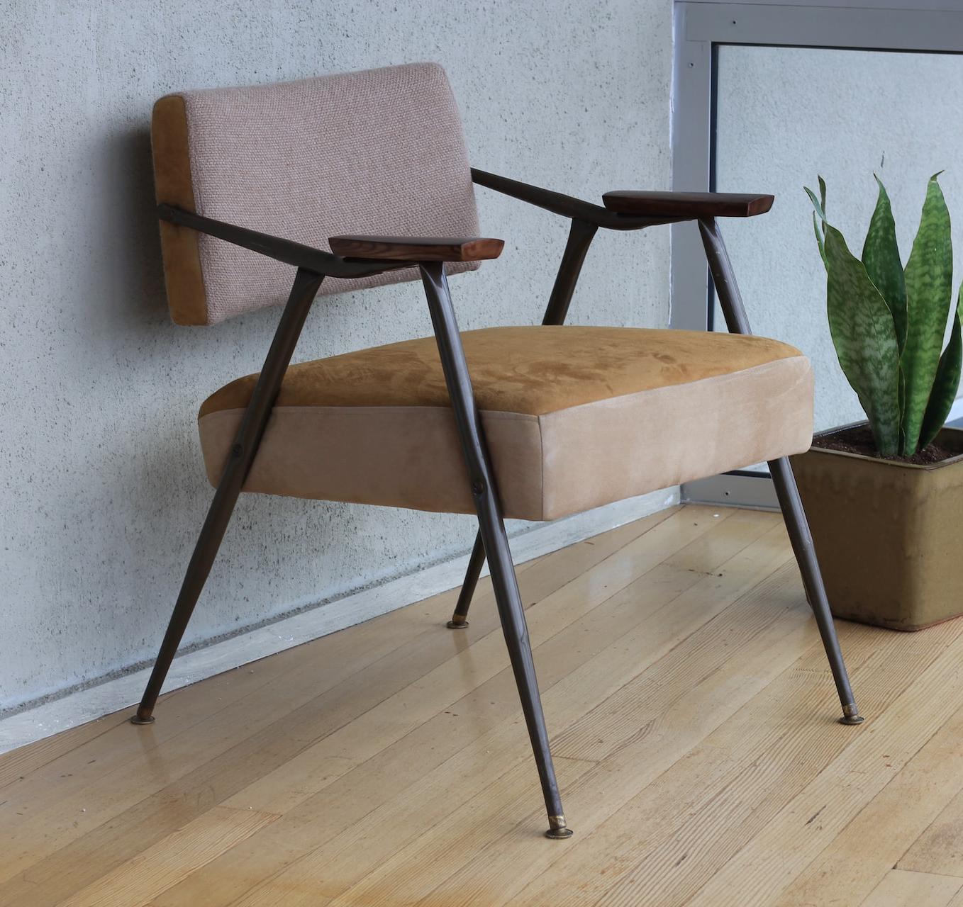 brown fabric padded armchair beside green snake plant inside room